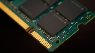 Macro view of a processor die surrounded by gold contact pins.