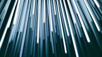 A spray of fibre-optic strands glowing at their tips against black.