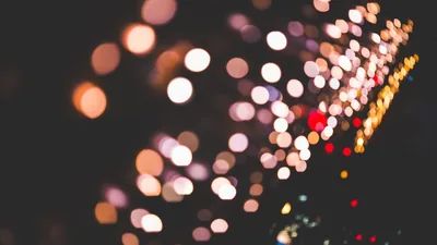 Out-of-focus city lights scattered across a night frame.