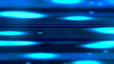 Streaks of blue light arcing across a black field.