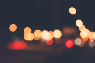 Defocused warm lights forming soft discs against a dark background.