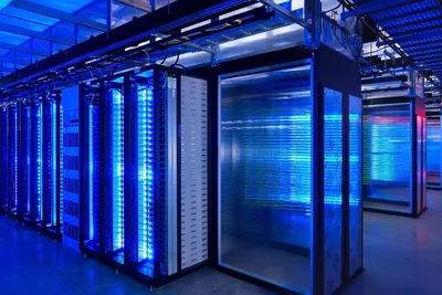 Rows of networking equipment in a dim server room.